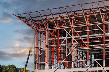 An unfinished building under construction on a metal frame.