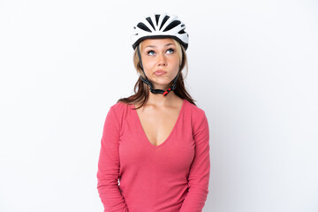 Young Russian woman wearing a bike helmet isolated on white background and looking up