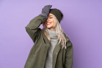 Teenager blonde girl with winter hat over isolated purple background has realized something and intending the solution