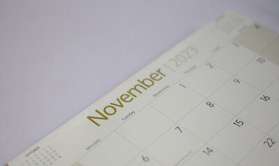 Selective focus shot of a closeup calendar of November 2023. November 2023 calendar isolated on background. 