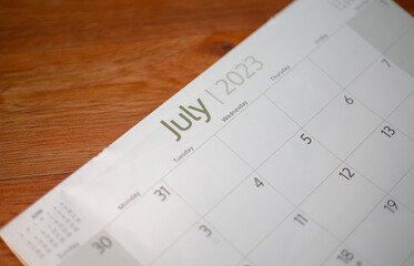 Selective focus shot of a closeup calendar of July 2023. June 2023 calendar isolated on background. 