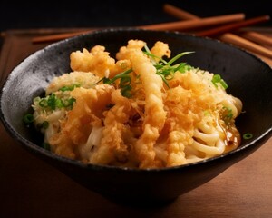 udon noodles with crispy tempura flakes and green onion garnish