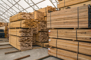 Stacks of lumber being stored in a warehouse