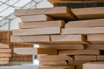 Stacks of lumber being stored in a warehouse - obrazy, fototapety, plakaty