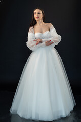 Fototapeta na wymiar Perfect bride in wedding dress on black background