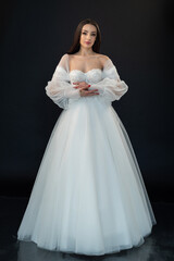 Fototapeta premium Perfect bride in wedding dress on black background