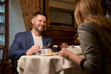 Happy man enjoying is dinner with woman