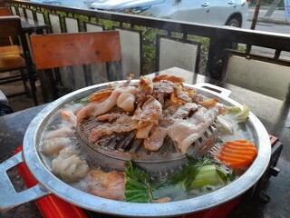 Lao style Sindard BBQ or Grilled pork belly with vegetable in hot pot