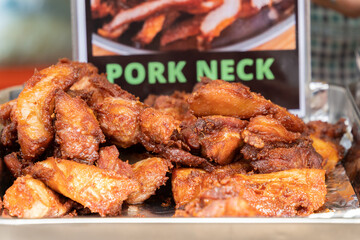 Deep fried pork neck selling at the food stall in the bazaar.