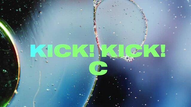 Animation of kick text over close up of liquid and baubles