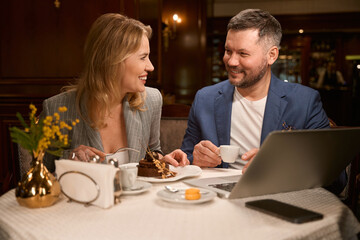 Male and female colleagues celebrating successful project