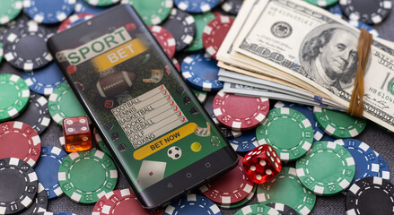 Mobile phone with bets, cards, chips, cubes and money dollars. Concept application for smartphone...