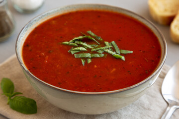 Homemade Tomato Basil Soup in a Bowl, low angle view. Close-up.