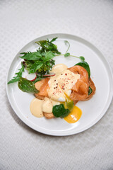 Tasty delicious brunch with salmon and poached egg on toast