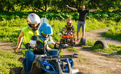 A child rides a quad bike through the mud. ATV rider rides