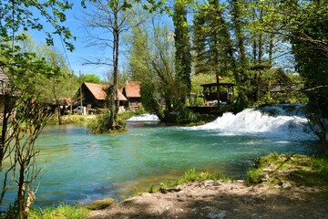 Fototapeta na wymiar View of Korana river flowing through the town of Slunj in Karlovac county, Croatia in summer