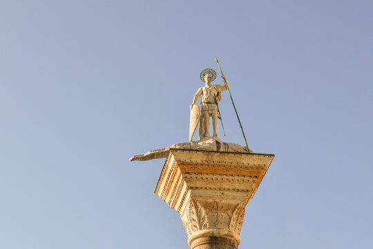 Top of the Column of San Todaro, Byzantine saint and warrior, first protector of the city, depicted in marble in the act of killing a dragon, St Mark's Square, Venice, Veneto, Italy