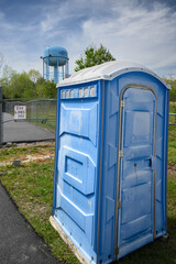 God loves you sign with port-a-potty and water tower