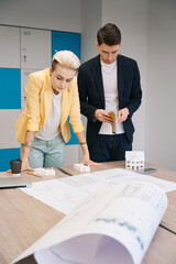 Fototapeta premium Architects studying house blueprint in the office