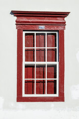 Old window with the number 231 at the top in red and white, vintage style. Historic city of Sabara. Minas Gerais. Brazil.