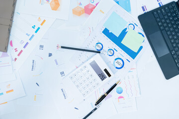 business desk with keyboard report chart pen and tablet on white table