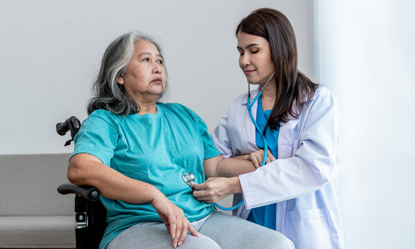 an Asian doctor woman Using a stethoscope Listen to abdomen of elderly woman patients. to annual health check of the elderly and health care concept.
