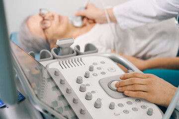 Elderly woman on an ultrasound examination of the thyroid gland