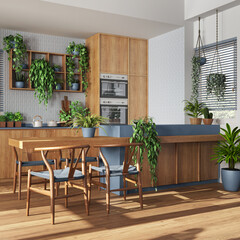 Wooden kitchen in white and blue tones with island and chairs. Cabinets with appliances. Love for plant concept. Modern urban jungle interior design