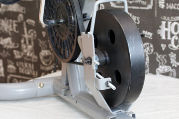 Elements of an exercise bike. Servicing the drive pulley and flywheel. Close-up.