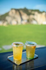 Iced lemon soda is on a steel tray.