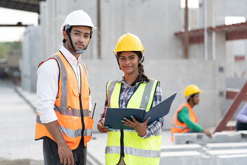 India engineer woman and Asia engineer man working with document at precast site work	