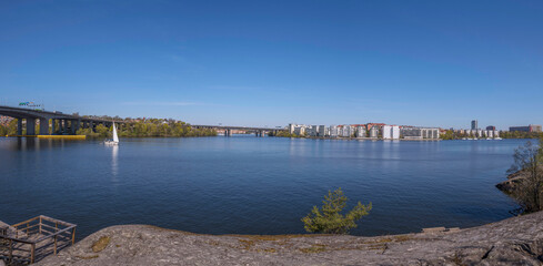 Panorama. The bay Essinge islands in the sea Mälaren , high way passing and waterfront houses, a sailing boat passing  to the archipelago, an sunny early  summer day in Stockholm