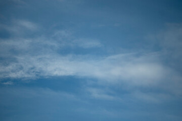 White, blue clouds scattered the blue sky. Beautiful Cloudscape.