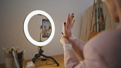 Vlogger hands demonstrating cosmetics at studio closeup. Woman filming tutorial