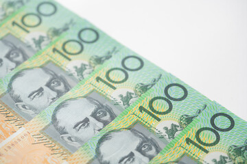 Obraz na płótnie Canvas close up of Australian one hundred dollar bills on white background, finance, currency and business concept