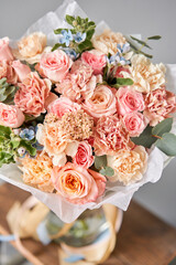 Beautiful bouquet of mixed flowers on wooden table. Floral shop concept . Beautiful fresh cut bouquet. Flowers delivery
