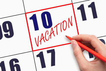 10th day of the month. Hand writing text VACATION on calendar date.