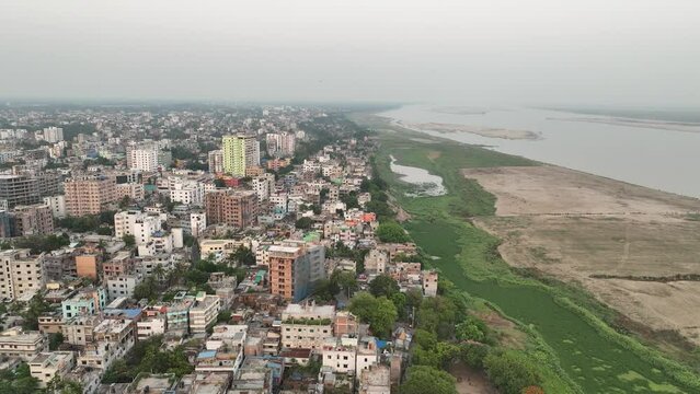 sunset flying south over Riverside Park on the upper west side of Rajshahi city.