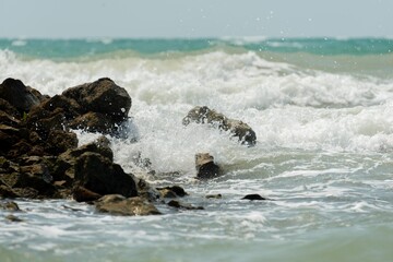 water flowing into the water waves crashing on high tide in the sea