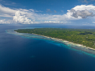 Seascape: Beautiful beach and tropical island and blue sky and clouds. Siquijor, Philippines