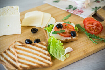 fried toasts with mozzarella, lettuce and tomatoes with herbs