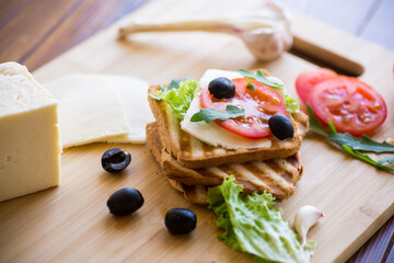 fried toasts with mozzarella, lettuce and tomatoes with herbs
