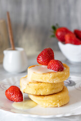 Cottage cheese pancakes with strawberry and sour cream.