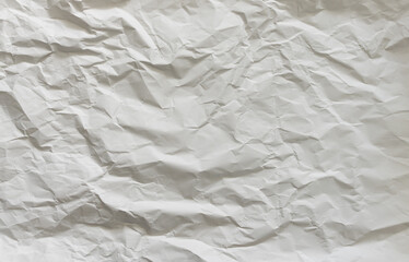 Blank paper background with wrinkles and random folds. Rough texture pattern of a blank sheet. Abstract backdrop as copy space.