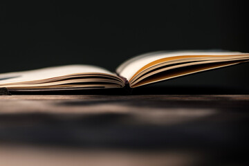 Simple image of a notebook book on a wood table.