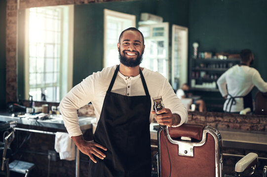 Barber shop, hair clipper and black man portrait of an entrepreneur with a smile. Salon, professional worker and male person face with happiness and proud from small business and beauty parlor