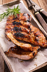 Barbecue veal spare ribs with hot honey chili marinade served as close-up on a design stone tray