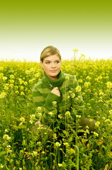 Young business woman relaxing on green meadow full of yellow flowers