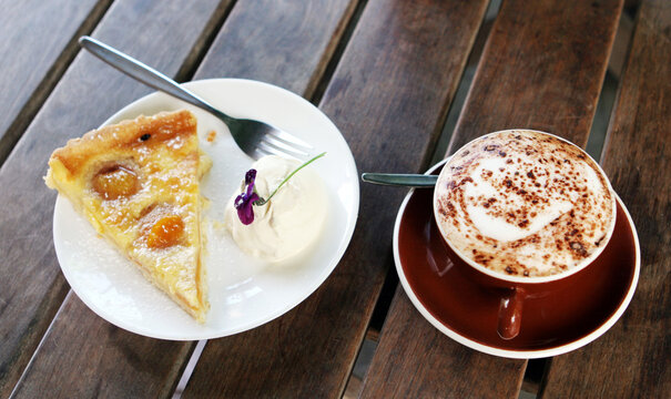 Apricot pie and cream with a cafe latte.
