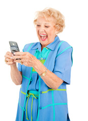 Senior woman laughing as she reads a funny text message.  Isolated on white.